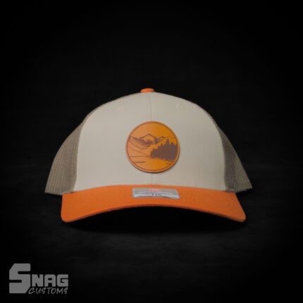 Mountain scene circle patch based on artistic render of Lake Como, Montana, leather patch hat